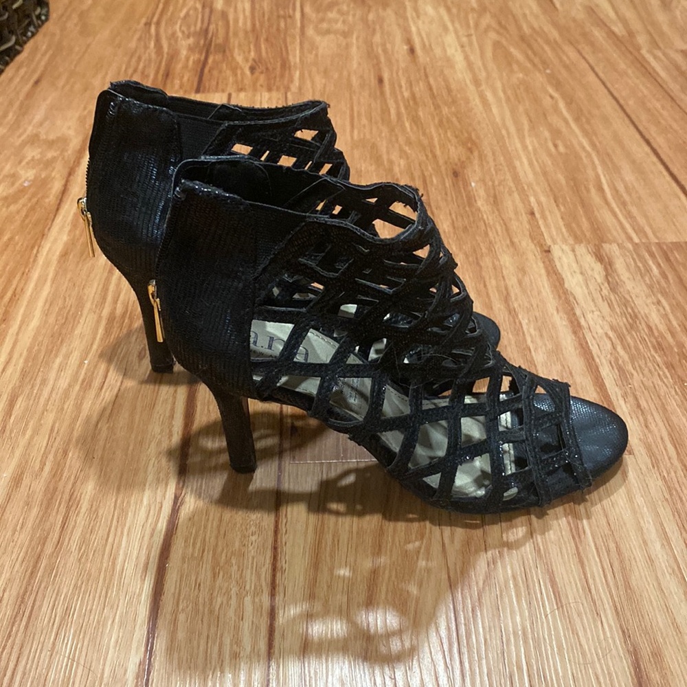 Black stiletto open-toe heels with cross pattern